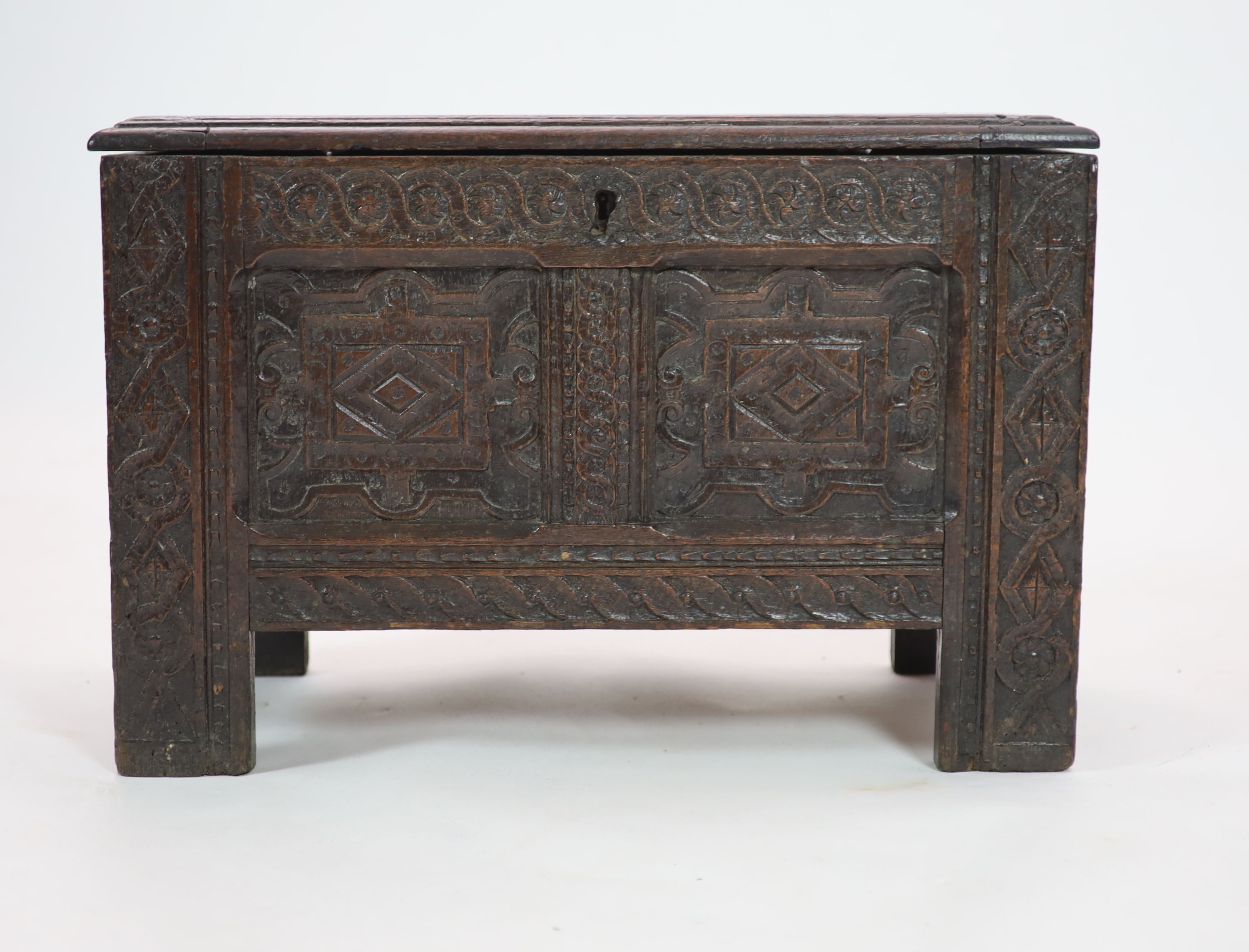 A late 17th/early 18th century small oak coffer (possibly West Country) the panelled front with Renaissance style carving H 46cm. W 70cm. D 34cm.